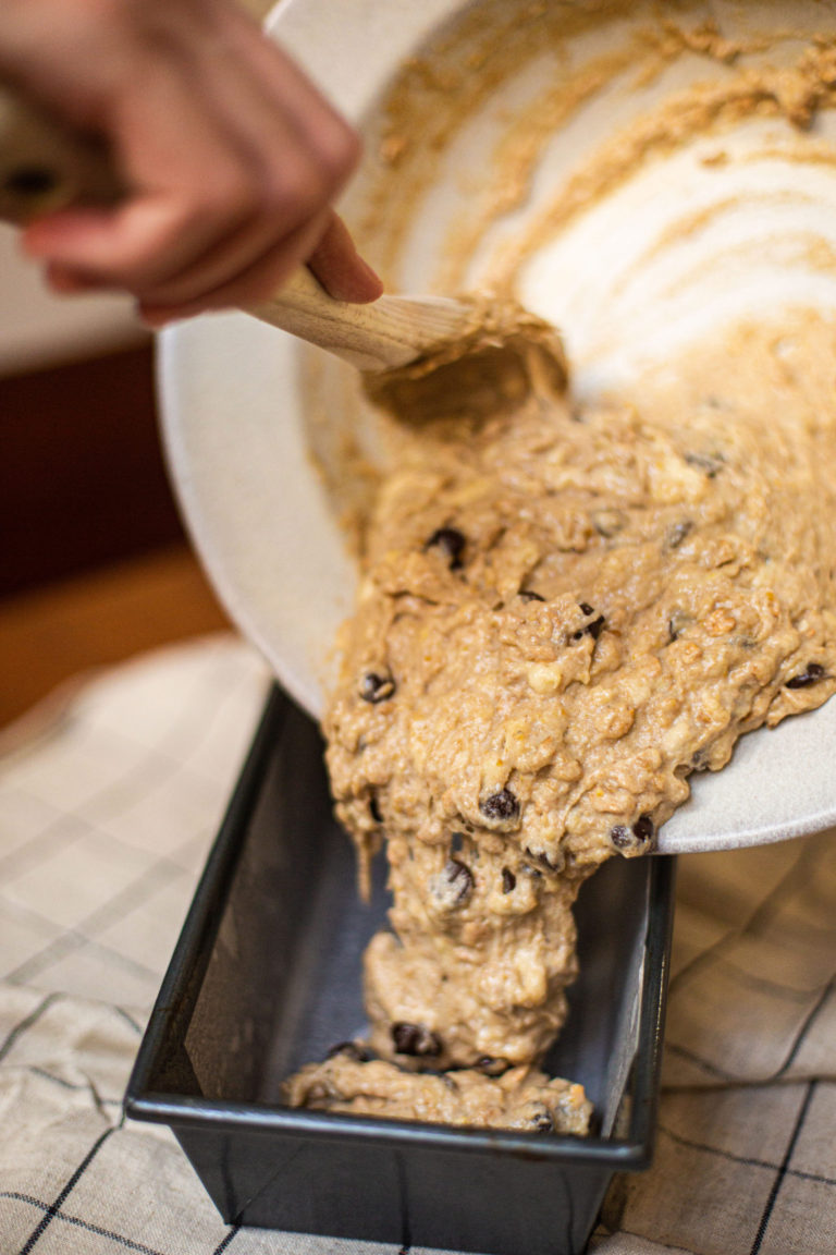 Adding your batter into your greased/parchment lined pan.